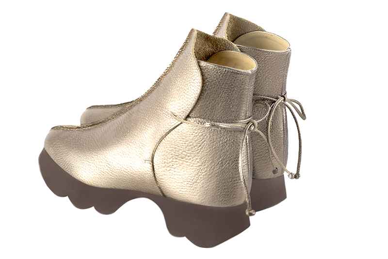 Gold women's ankle boots with laces at the back. Round toe. Low rubber soles. Rear view - Florence KOOIJMAN